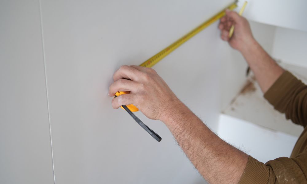 Measuring and Marking Wall for Mirrored Cabinet Installation