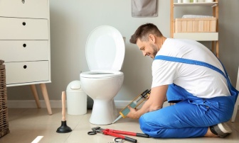 Man installing a new toilet