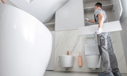 Man Installing Fitted Bathroom Furniture